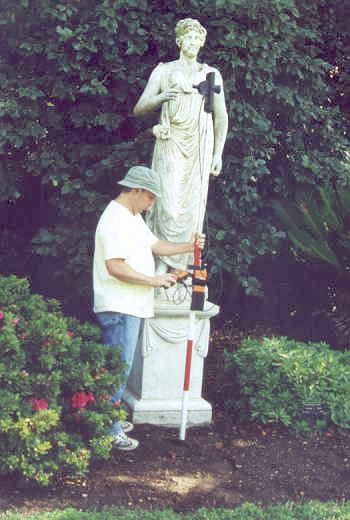 Julio Barrantes maps a statue with a robotic total station