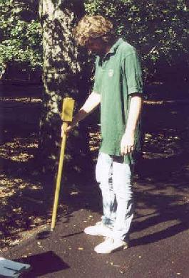 Tim Thibault uses a metal detector to locate a control point.